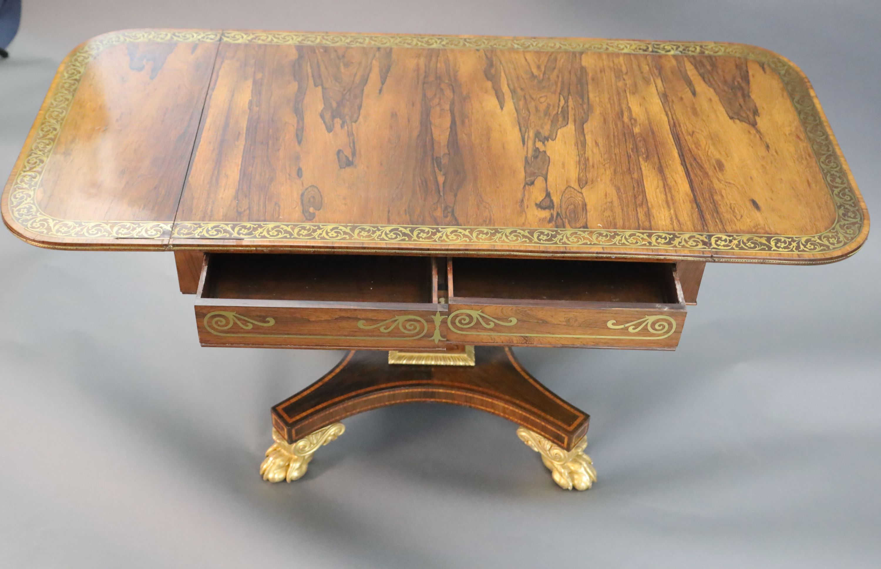 A Regency brass inset rosewood sofa table, W.3ft 2in. D.2ft 3in. opens out to 4ft 11in. H.2ft 4in.